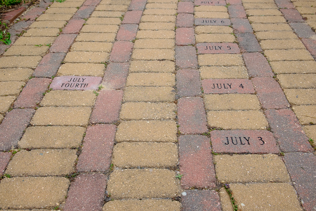 Photograph of bricks with each day engraved on it