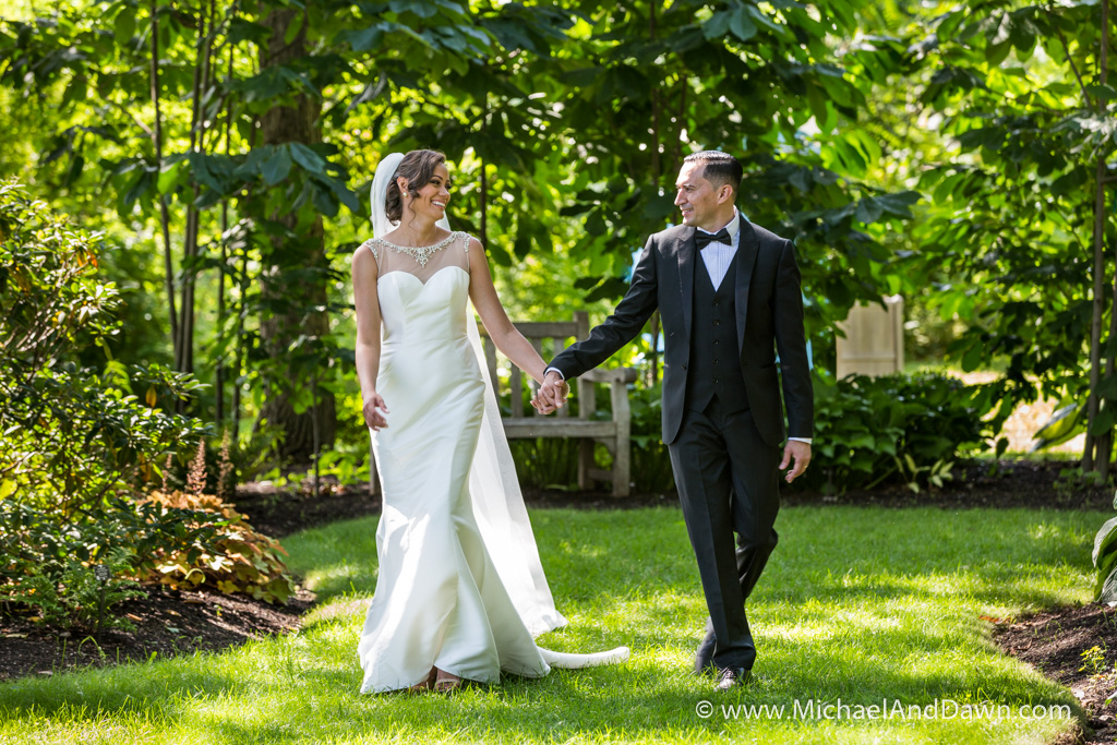 picture of groom walking with bride in garden